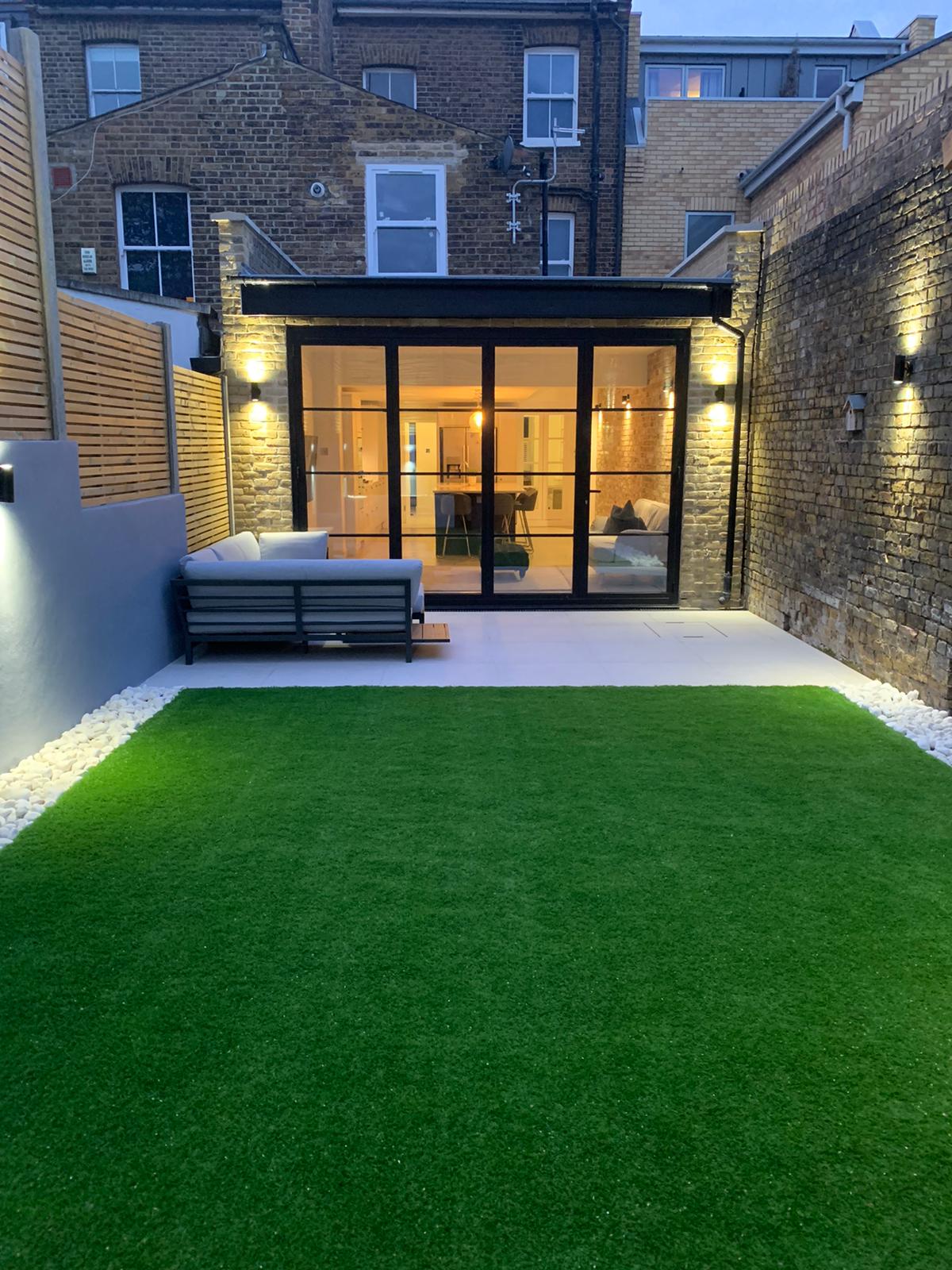picture of house extension at dusk with lights on